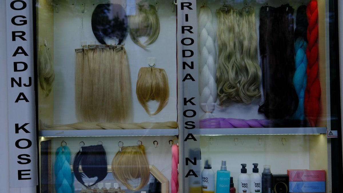 Display case filled with various hair extensions and hair products.